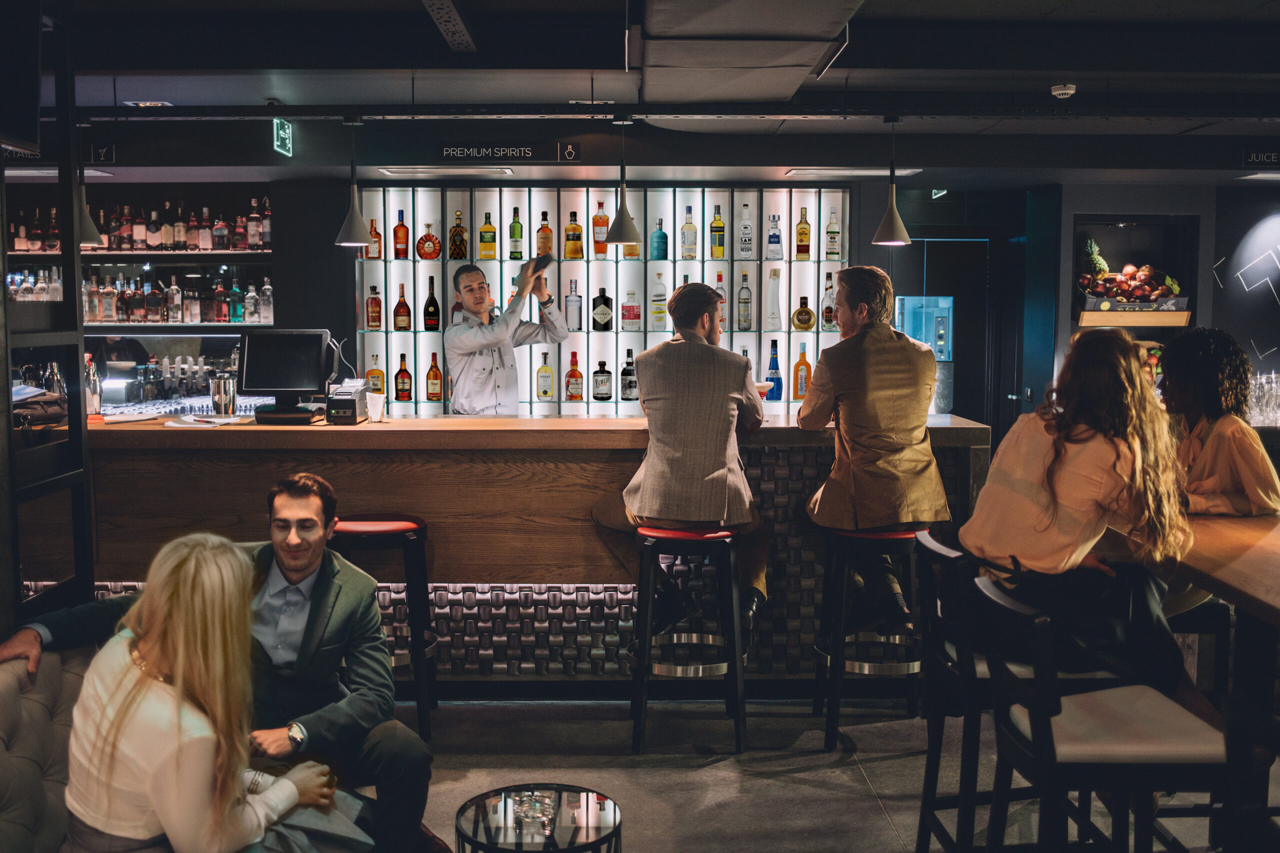 People sitting and chatting at a bar.